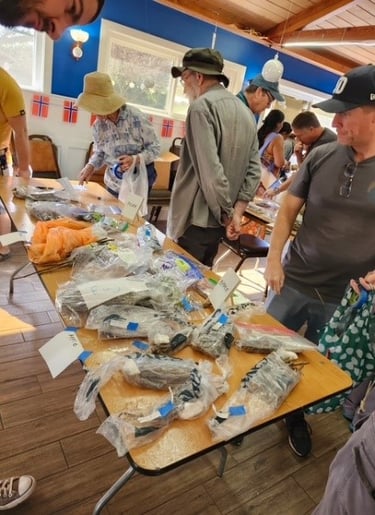 People browsing tables of bagged plant cuttings