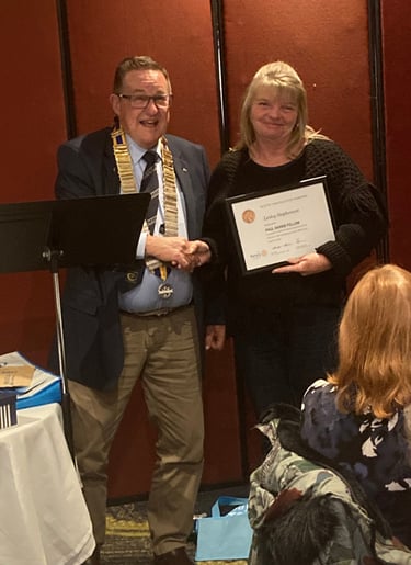 2024 President Rod presents Lesley Stephens from Bunnings Fyshwick with the Paul Harris Fellow award