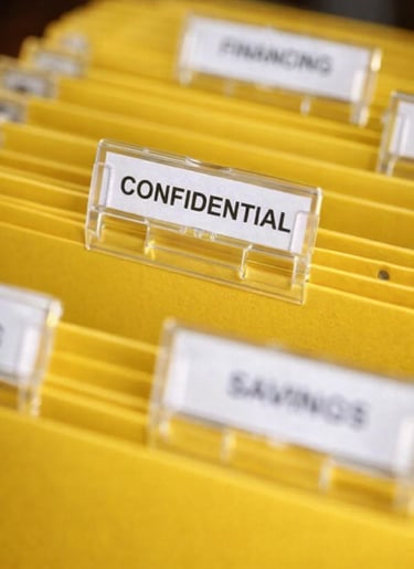 Yellow hanging file folders with a confidential label for secure document storage and organization.