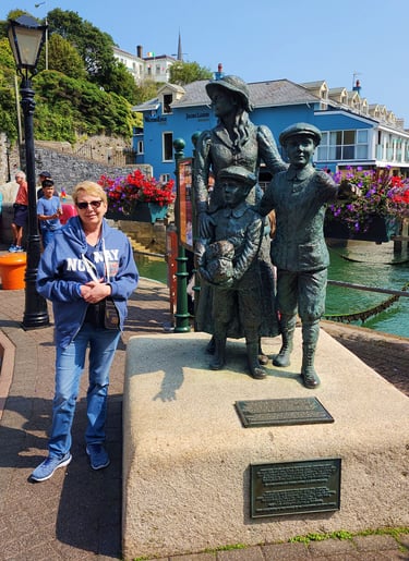Lady at Annie Moore Statue in Cobh, Ireland