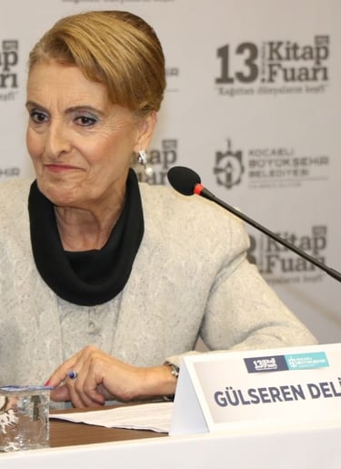 a woman in a gray sweater and black scarf