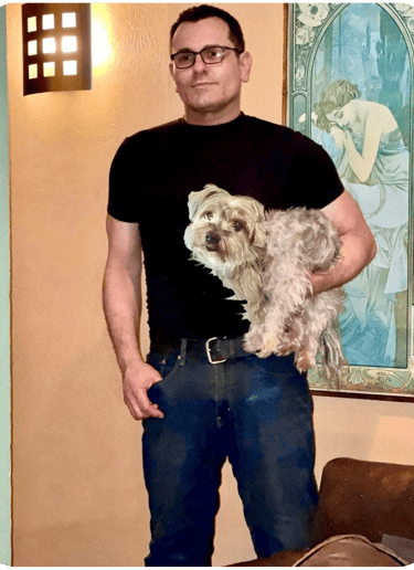 The artist Jason Marks holding Sparky his Yorkshire Terrier