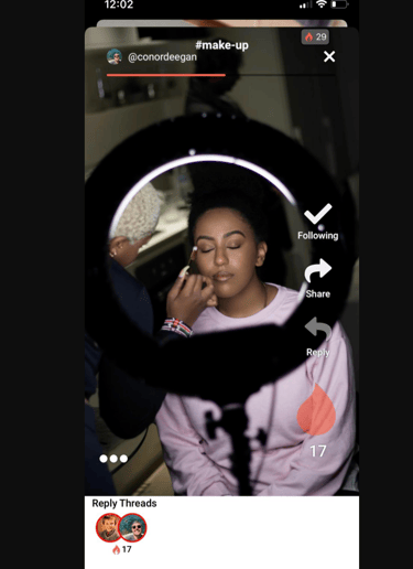 a woman with a pink shirt and makeup