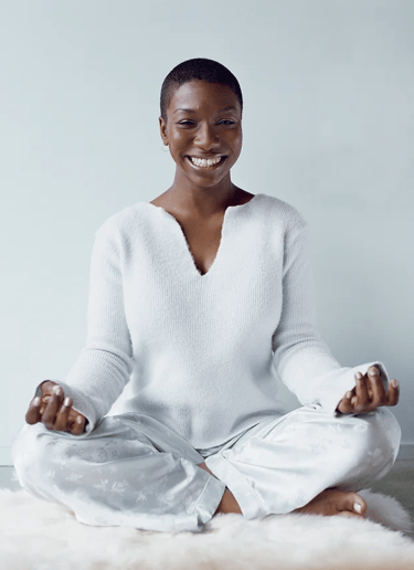 woman smiling, tranquil, healing from stress.