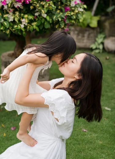 Natural mother and daughter moment captured in a tropical garden during a relaxed family photography session in Seminyak