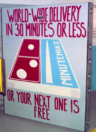 a sign on a blast door that says world wide delivery in 30 minutes or less