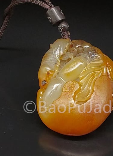 a yellow jade pendant with a dragon on it Hotan Jade