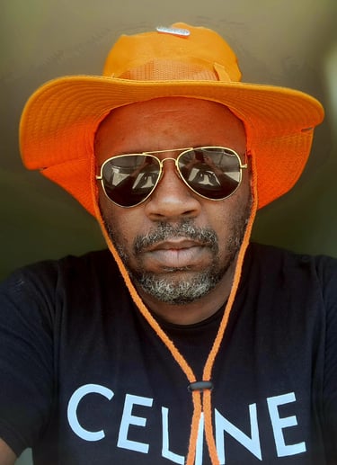 a man wearing a hat and sunglasses