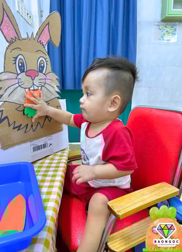 a young child is playing with a cardboard box