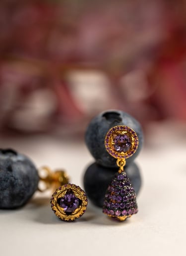 a bunch of blueberries and a pair of earrings