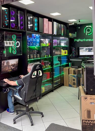 a man sitting at a desk with a computer monitor and a gaming chair