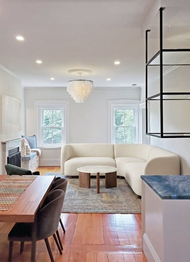 Open plan living area, curved bouclé sectional, capiz chandelier, cobalt quartzite bar, Charlestown Boston
