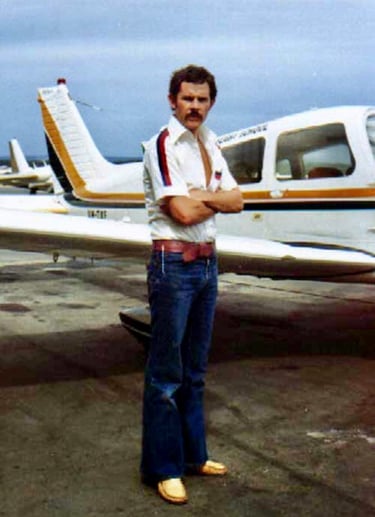Peter Pickering stands in front of a Piper Cherokee in which he learnt to fly