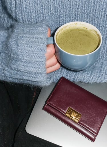 relax while you system runs automated. SAHM with drink and closed laptop relaxing