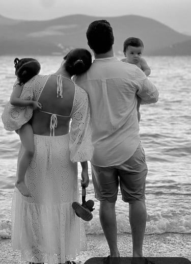 A couple doing couples therapy on the beach with their kids at hand