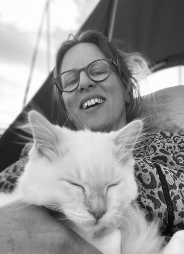 a woman is holding a cat