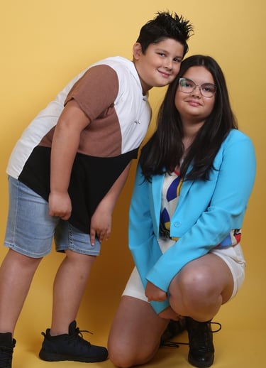 a boy and girl posing for a photo