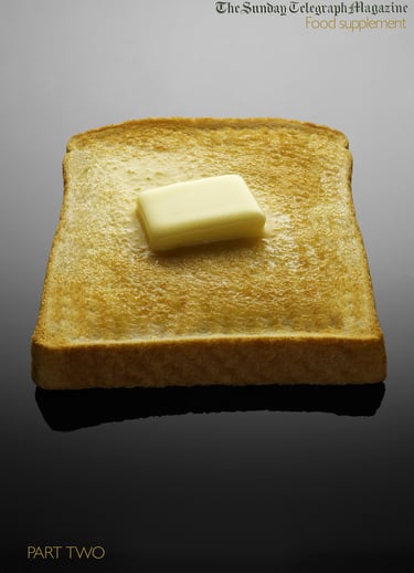 magazine cover with piece of toast and melting butter on grey