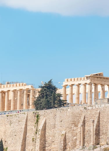 a large stone structure with a few trees in the background