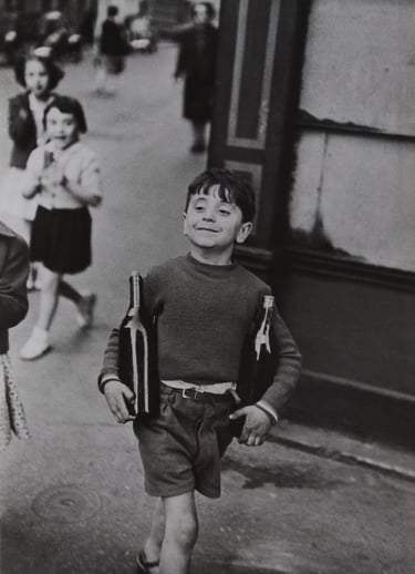 A Cartier-Bresson photo - boy carrying wine bottles
