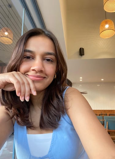a woman sitting at a table with a plate of food