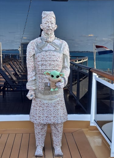 Statue holding little green companion