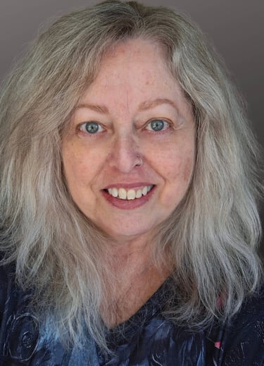 A middle-aged white woman with green eyes and blonde hair