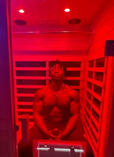 Muscular man relaxing in a Far Infrared Sauna.