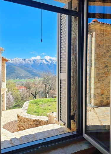 a window with a view of a mountain range