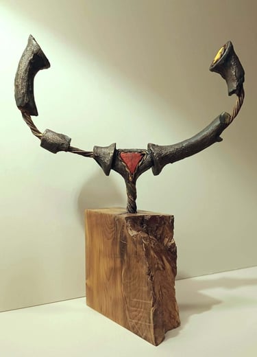 A semi circular, linear sculpture, painted bronze with red and yellow details, on yew plinth.