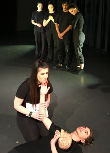 a woman is sitting on a stage with a man and a woman