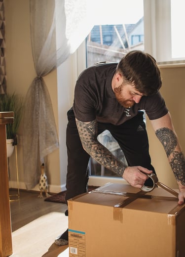 deanos removals tapping a box in a worcester home