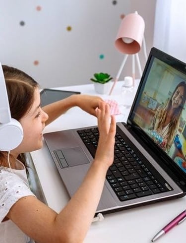 A young female student having online maths lessons.