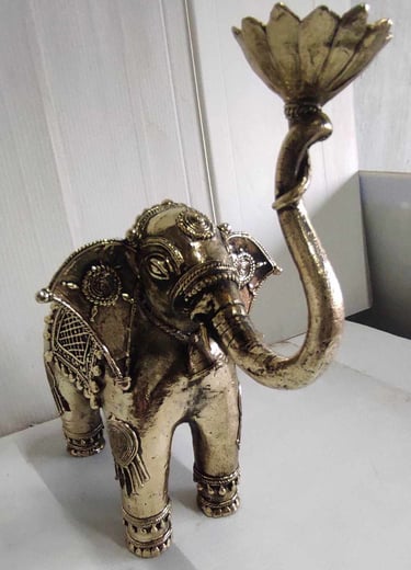 "Tribal-style brass elephant holding lotus flower, raised trunk posture, right side-Export-ready"