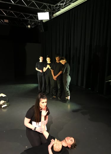 a woman is sitting on a stage with a man and a woman