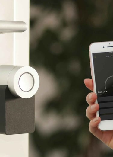 a person holding a smart phone in front of a door