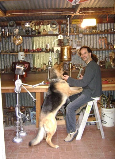 Artist Tal Avitzur in workshop with canine friend Mancha.