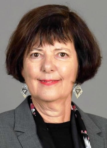 a woman in a gray suit and black tie
