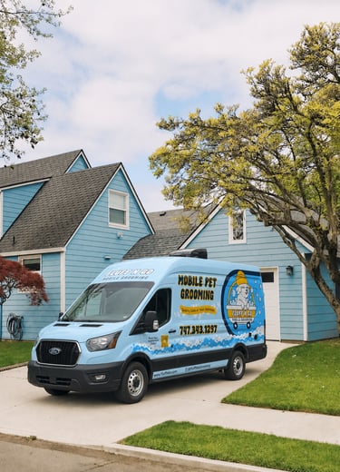 Fluff N Go mobile pet grooming van parked on a driveway in a Los Angeles neighborhood