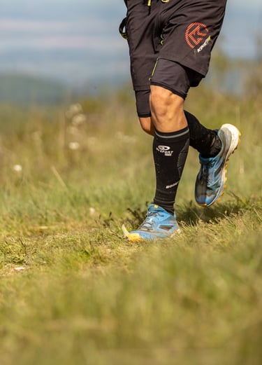a man running on a grassy field with a soccer ball