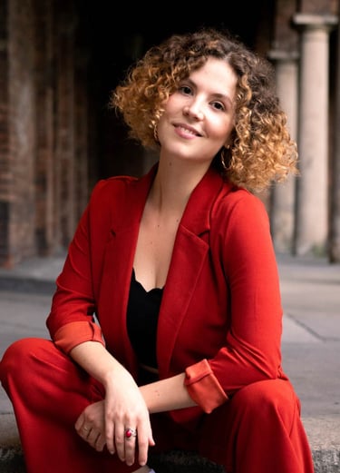 a woman in a red suit and white sneakers