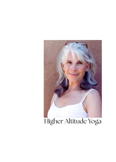 Portrait of a smiling senior yoga student at Higher Altitude Yoga against a warm wall.