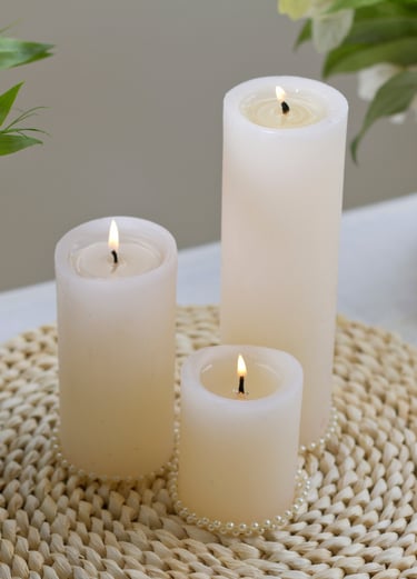 three candles are sitting on a table