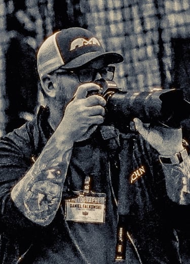 A photo of Dan Falkowski of DanFalk Designs holding a camera