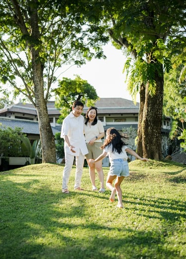 Family running together across the lawn at InterContinental Bali Resort Bali