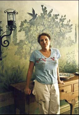 Christine in front of one of her murals