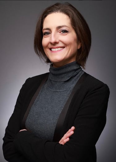 Portrait Louise Mac Sweeney Funeral Celebrant Grey Polo, black blazer, arms crossed