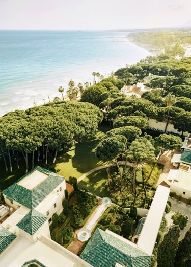 Aerial view of Villa El Rincon, luxury beachfront villa in Marbella with private pool, lush gardens, and panoramic sea views.