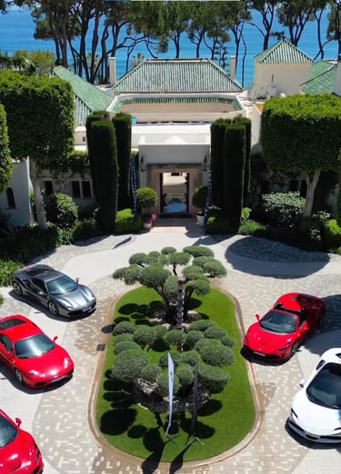 Corporate event at Villa El Rincon featuring luxury sports cars displayed in the courtyard