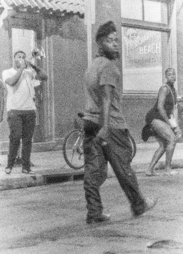 a man walking down the street with a bicycle